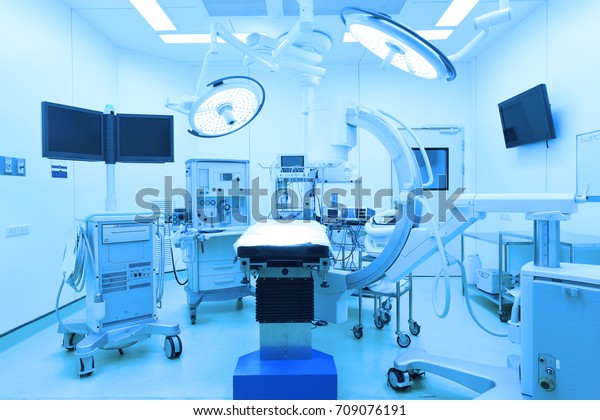 equipment and medical devices in modern\
operating room take with art lighting and blue\
filter