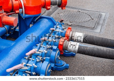 Equipment for pumping fuel. Hoses are connected to fuel machine. Petrol reloading system. Hoses for pumping fuel. Equipment for transportation and storage gasoline. Blue pipeline for pumping diesel