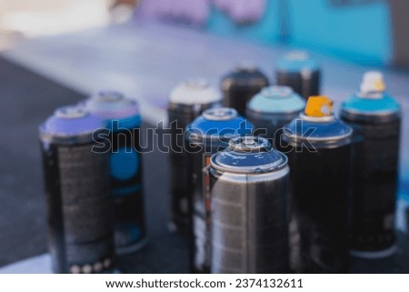 Equipment set for street art, spray cans bottles with aerosol spray paint, creating graffiti and mural on the walls, with paint can, brush, roller, street artist kit for stencil murals and grafiti