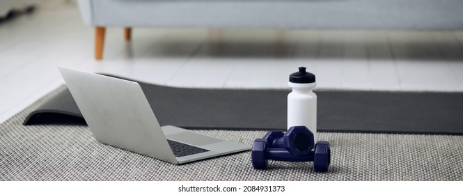 Equipment For Training At Home. Cropped Photo Of Dumbells, Laptop And Bottle Of Water.