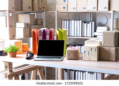 Equipments for SME online business , delivery business laptop, barcode, boxes, checking product on stocks or parcels. Small business working at home office.