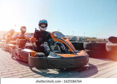 Equipped drivers are sitting in a racing car. Ready for battle, championship. Go karts racing, sreet karting, rent. extreme sport. fun entertainment for drivers. soft light. copy space for text