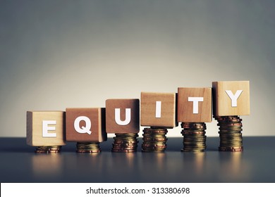 equity text written on wooden block with stacked coins on grey background - Shutterstock ID 313380698