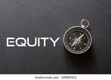 Equity Word Written On Black Background With Compass