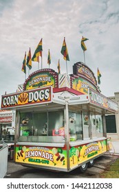 ERATH, L.A. / USA - JULY 4, 2019: A corn dog, lemonade stand and nacho booth food cart at a street fair, located at a carnival for Fourth of July, Independence day festival in Erath, Louisiana.