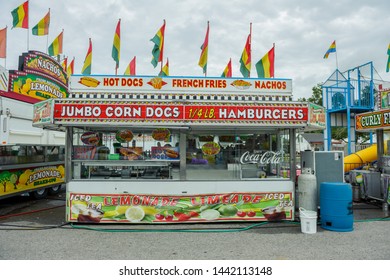ERATH, L.A. / USA - JULY 4, 2019: A corn dog, hamburgers and nacho booth food cart at a street fair, located at a carnival for Fourth of July, Independence day festival in Erath, Louisiana.