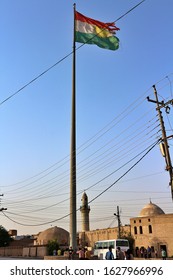 Erbil, Kurdistan / Iraq - 27 September 2017: Ripped Kurdish Flag In Erbil Citadel Downtown City Centre People Mosque Minaret Golden Light Sunset