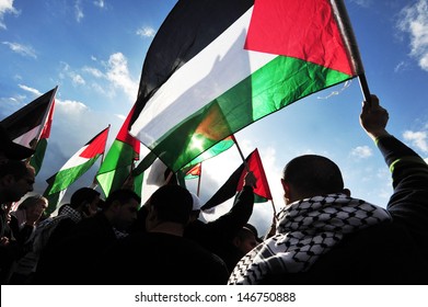 EREZ CROSSING, ISR-DEC 31 2009:Rear view of Palestinians mob carry flag sof Palestine.On April 2013, 132 (68.4%) of the 193 member states of the United Nations have recognized the State of Palestine.