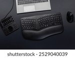 Ergonomic keyboard and ergonomic mouse as ergonomic home office equipment for freelance work and healthy workplace for notebook and clean desktop for efficient work from home for video editing graphic