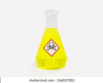 Erlenmeyer flask with Yellow liquid and chemical hazard warning symbols labels (acute toxicity symbol) on white background.	
