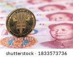 e-RMB gold coin, over 100 yuan banknotes, conceptual image of the digital version of the yuan. Chinese decentralized currency