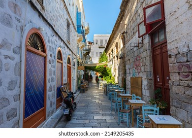 Ermoupoli, Greece - July 6, 2021: Typical Mediterranean narrow street alley on the Greek island of Syros. Located in the Aegean Sea in the Cyclades archipelago. Ermoupoli, the capital of cyclades