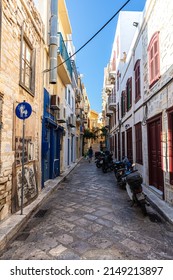 Ermoupoli, Greece - July 6, 2021: Typical Mediterranean narrow street alley on the Greek island of Syros. Located in the Aegean Sea in the Cyclades archipelago. Ermoupoli, the capital of cyclades