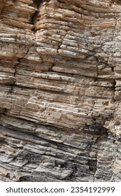 Eroded cliff wall. Stone layers close-up.