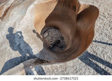 Eroded pothole carved into the solid granite bedrock of Desolation Wilderness in California