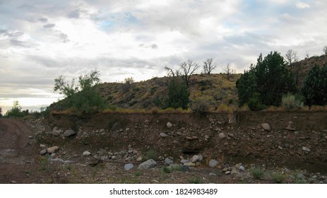 Erosion along a wash exposes layers of soil in rural Nevada. - Shutterstock ID 1824983489