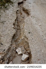 Erosion Grooves After Rains In A Dirt Road. Deep Ground After A Storm. Lack Of Drainage Will Cause Serious Damage To The Surface Of The Bike Path Or The Forest Timber Yard