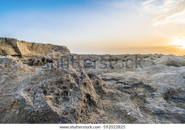 Erosion on the rocky surface, sunset with view on\
rocky ciffs.
