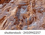 Erosion produces pattern in the rock wall near Cassidy Arch at Capitol Reef National Park in Utah, USA