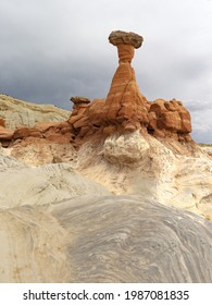 Erosion of the red sandstone - protected by a lava capstone - form a toadstool rising from the white layer beneath it  Found near Kanab, Utah 