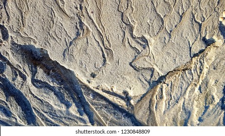 Erosion traces in the sand look the same, like dry rivers in deserts
