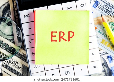 ERP - Enterprise resource planning theme. Concept word ERP on a yellow sticker on the calculator against the background of dollar bills