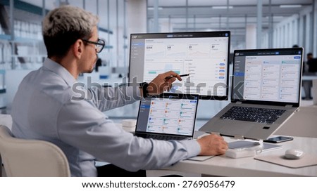 ERP Expert Evaluates Cloud-Based Integrated Management Software On Laptop For Strategic Business Planning