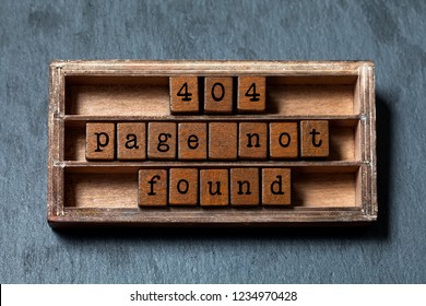 Error 404 page not found concept. Vintage box, wooden cubes with old style letters. Gray stone textured background.