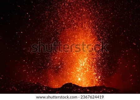 Eruption of the Etna volcano at sunset, with explosions and lava flow
