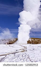 Eruption of Old Faithful Geyser at Yellowstone National Park in the Winter