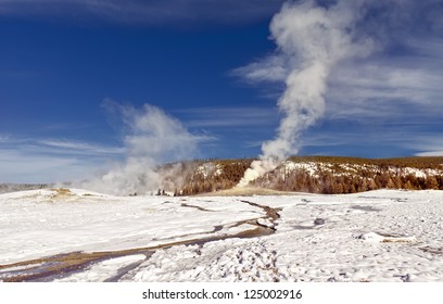 Eruption of Old Faithful Geyser at Yellowstone National Park in the Winter
