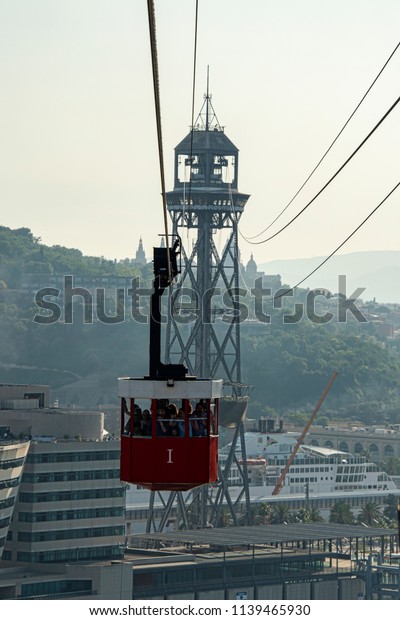 ES, Barcelona Port Cable Car - June 2018:\
Loaded cable car coming in to Station. Completed in 1931 the cable\
car is apopular tourist\
attraction.