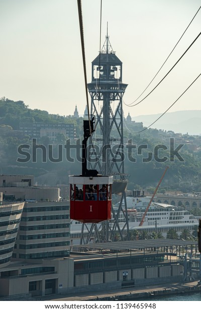 ES, Barcelona Port Cable Car - June 2018:\
Loaded cable car coming in to Station. Completed in 1931 the cable\
car is apopular tourist\
attraction.