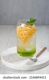 Es Blewah. Indonesian Cold Fruity Drink Of Cantaloupe Strips With Syrup, Basil Seeds On Top;