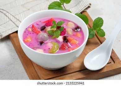 Es buah or sop buah-is an Indonesian iced fruit cocktail dessert. This cold and sweet beverage is made of diced fruits mixed with shaved ice or ice cubes, and sweetened with liquid sugar or syrup. - Shutterstock ID 2133225941
