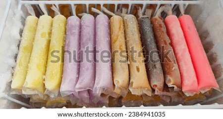 Es Mambo, es lilin, es loli, es potong, popsicles in the freezer. Homemade Ice cream, wrapped in long plastic. Typical Indonesian children's snacks with various flavors. Stock fotó © 