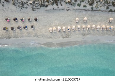 Es Ministre beach, in the morning. Umbrellas and the sea. - Shutterstock ID 2110005719