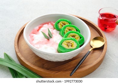 Es Pisang Ijo, traditional dessert from Makassar, South Sulawesi, Indonesia, made from banana which is rolled with a mixture of wheat flour, rice flour and coconut milk. Served with pureed and syrup.
 - Shutterstock ID 1992773030
