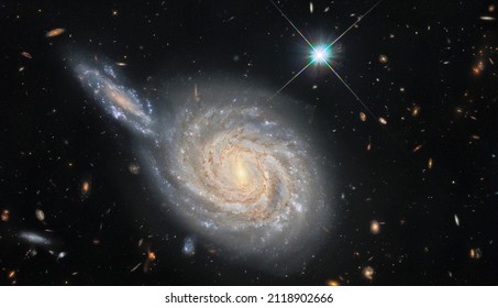 ESA Hubble Galactic Conjunction. The spiral galaxy NGC 105, which lies roughly 215 million light-years away in the constellation Pisces.