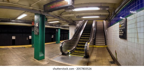 Escalator, moving staircase, Dirty entrance to the empty 59 street train subway station big sign on a wall, green line number 6, New York, Very wide shoot,  Manhattan, United States of America,10.12.2