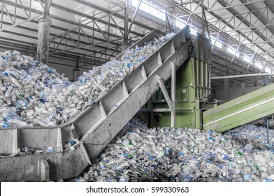 Escalator With A Pile Of Plastic Bottles At The Factory For Processing And Recycling. PET Recycling Plant