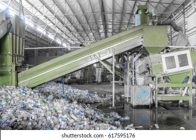 escalator with a pile of plastic bottles at the factory for processing and recycling. PET recycling plant