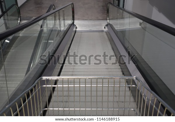 escalator for trolley\
shopping car in depart meant store for customer use in case they\
have a lot of\
products