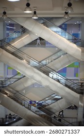 Escalators inside a building creating a geometric pattern