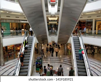 Escalators And People In Canary Wharf Shopping Centre, Docklands Area Of London, UK. June 2018.