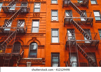 Escape fire ladders at beautiful colorful house facades in New York. Manhattan New York City - Background texture pattern of Buildings. 