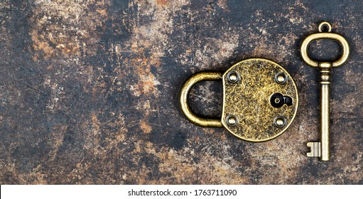 Escape Room Game Concept. Web Banner Of A Vintage Gold Key And Locked Padlock On A Rusty Metal Background.
