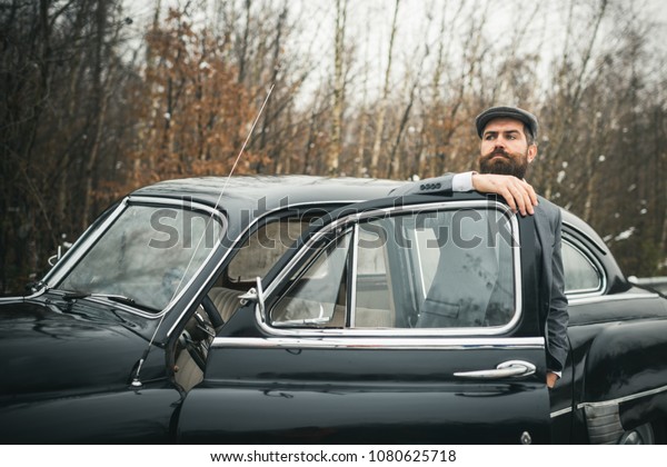 Escort man or
security guard. Bearded man in car. Call boy in vintage auto. Retro
collection car and auto repair by mechanic driver. Travel and
business trip or hitch
hiking.