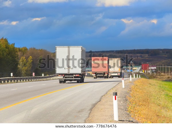 escort of trucks moves\
on mountain road