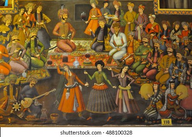 Esfahan, Iran - January, 01, 2012: Dinner with belly dances in the king palace on the wall fresco in palace Chehel Sotoun